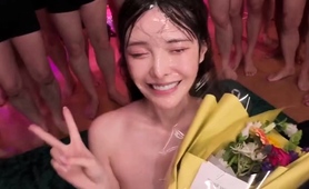 Asian slut drowning in a sea of hard cocks and hot cum
